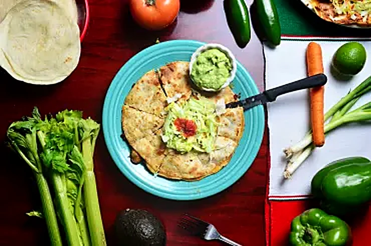 Quesadilla with guacamole, fresh vegetables and tortillas